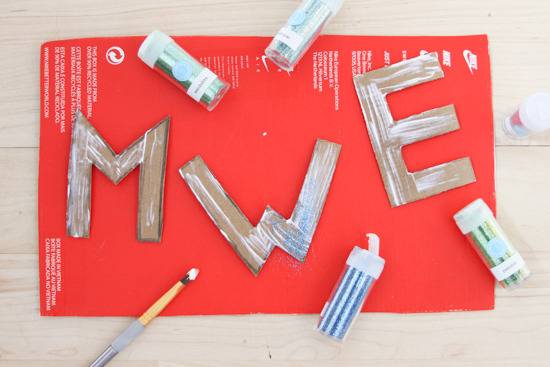 Alphabetical cardboard pieces glued and spread with paint brush.