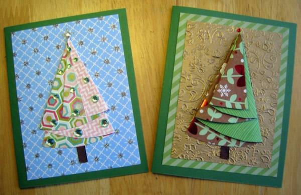 Two raised cut out Christmas cards with Christmas trees on them.