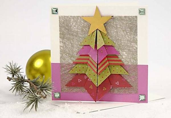 A homemade card has a crafted Christmas tree on it.