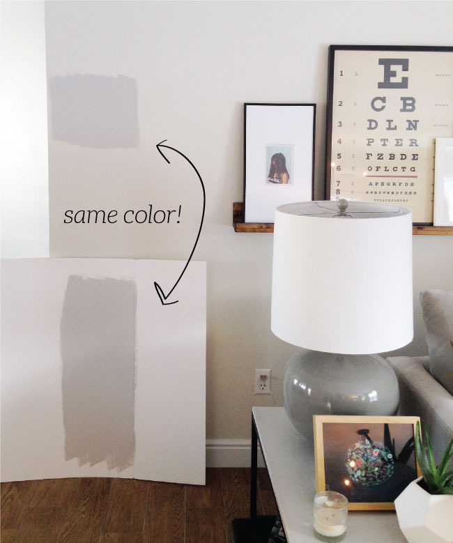 White room with a lamp and hanging picture hanging walls