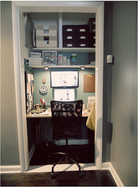 A closet has been turned into a small office with a desk inside.
