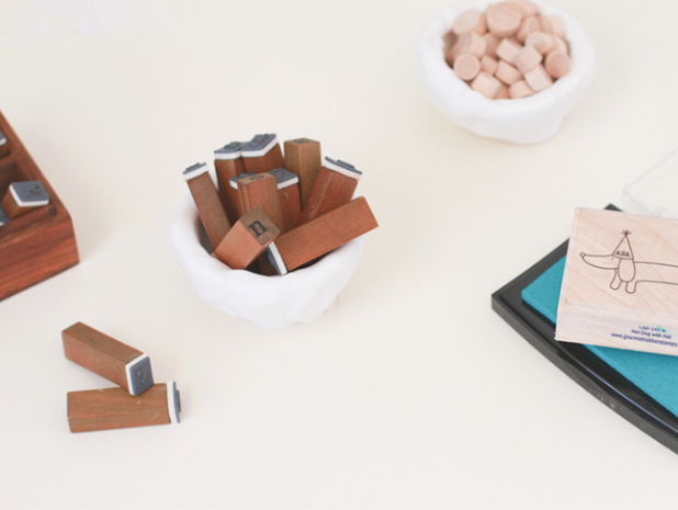 A white desk full of accessories in a 2 pots