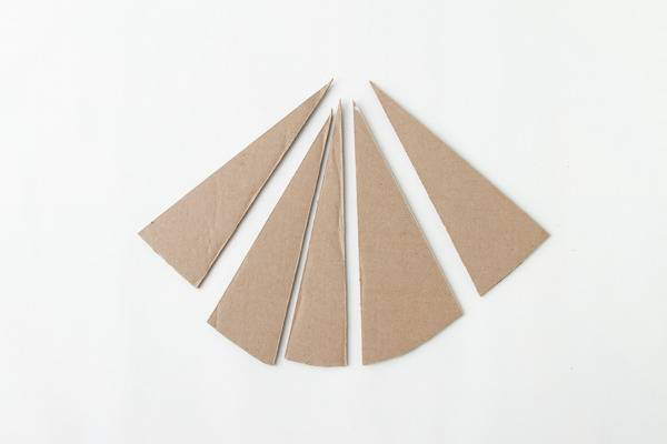 Triangles of brown material are spread out on a white surface.