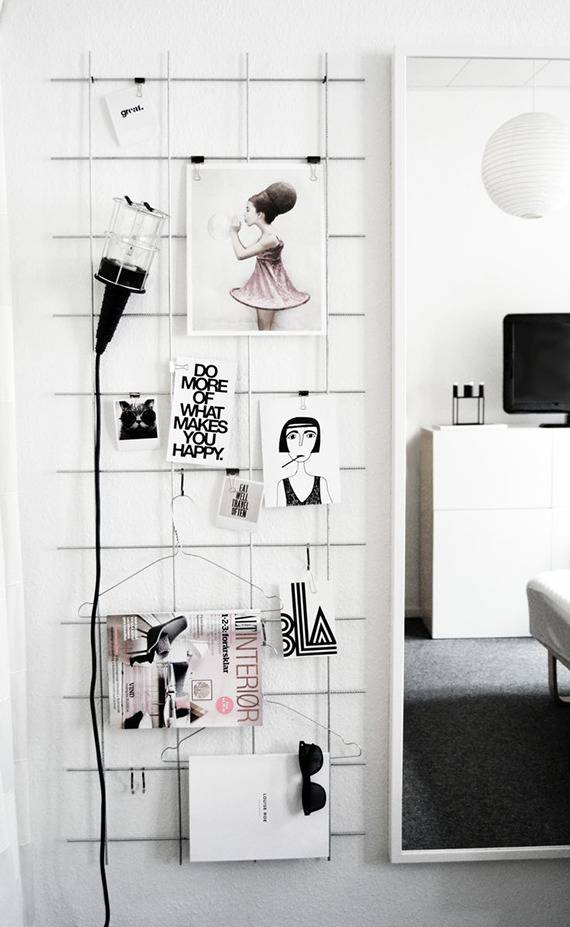 A black lamp next to several objects hanging on a wall.