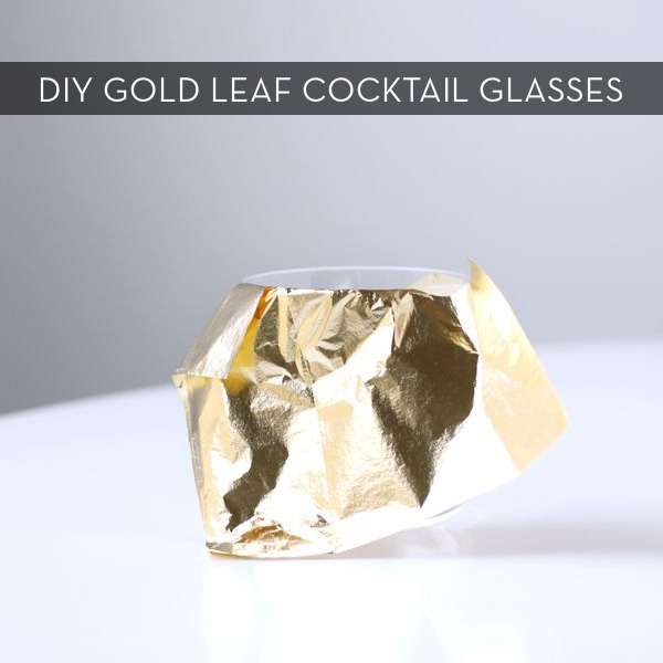 A piece of gold leaf leaning against a glass.
