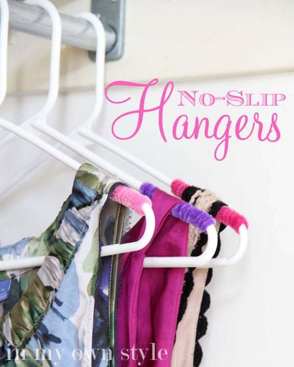 Three hangers with colorful dresses on them.