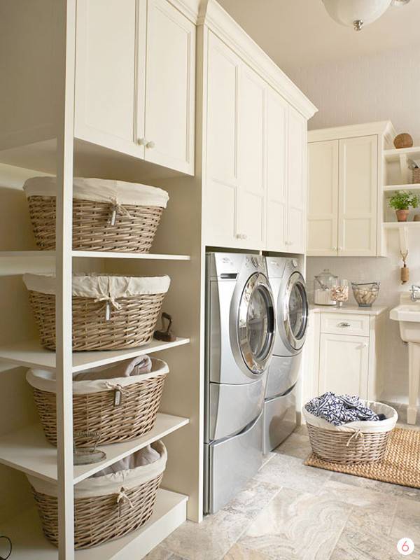 Laundry room with laundry baskets, shelves, cabinets and washing machines.