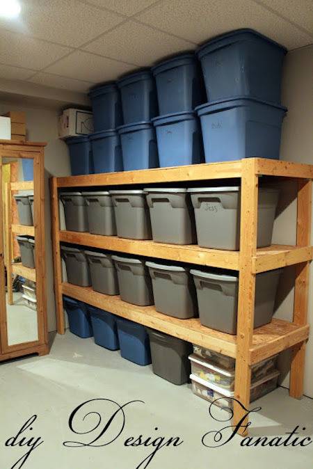A three level wooden shelf holds multiple rectangular bins.