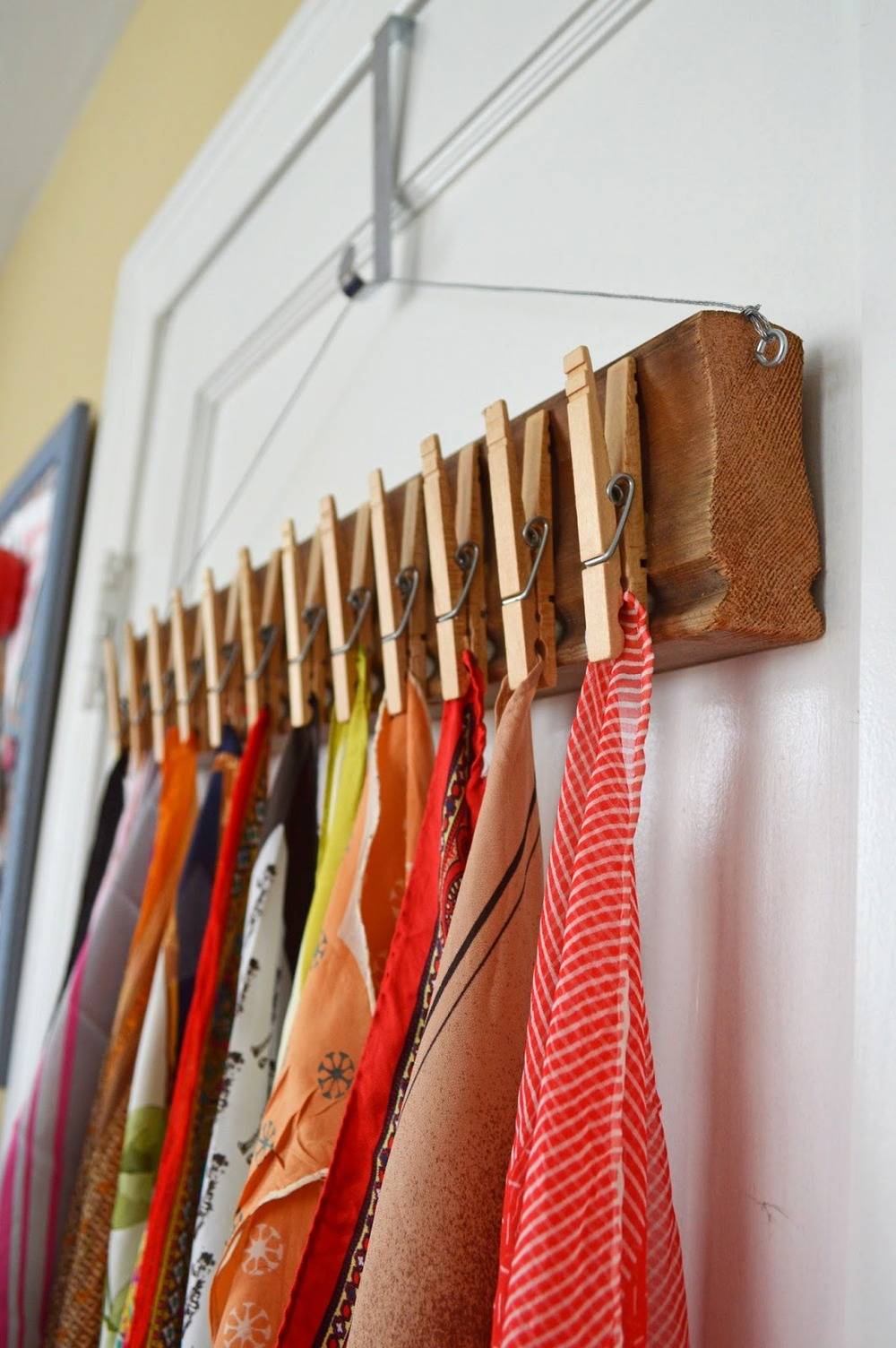 Cloths are hanging in an order to a hanger.