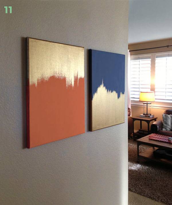 Two orange and blue paintings with gold, on the corner wall of the living room.