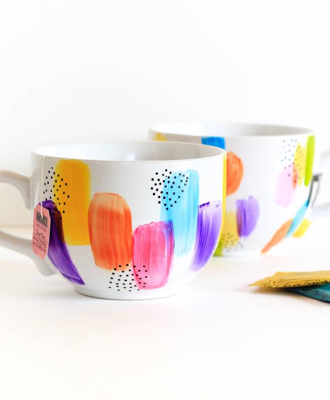 Cups with colorful smudges sit next to each other.