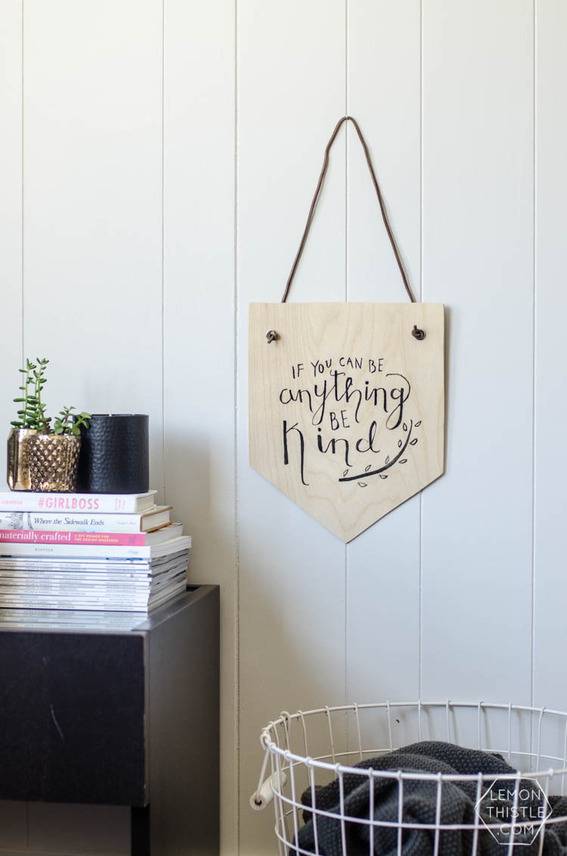 A sign is hanging on the wall over a white basket.