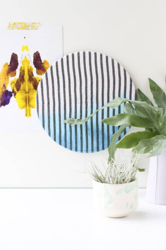 Cork plant mat with stripes and potted plants on the table.