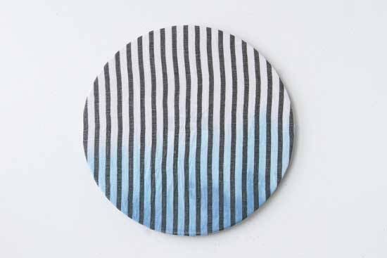 A round disk has vertical stripes on it.