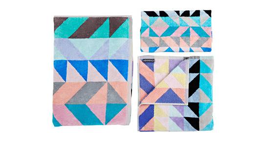 Three quilts with light colored geometric patterns are shown.
