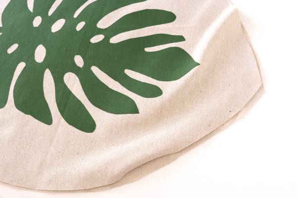 White cloth with green leaf design on it.