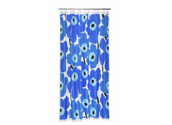 A shower curtain has blue colored flowers.