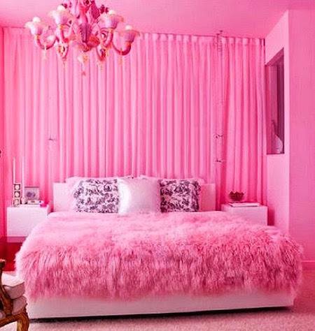 a pink room with fluffy blankets and cozy pillows