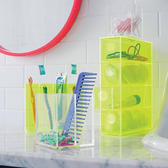 A yellow holder in a white bathroom holds accessories.