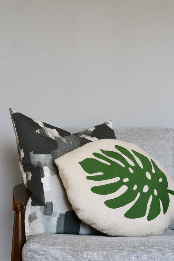 "Tropical leaf pillow on the chair."