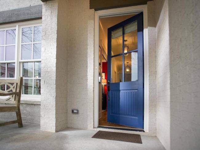 A porch is shown with an open blue door.
