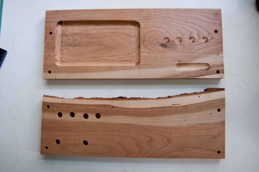 Pieces of a wooden desk organizer waiting to be assembled on a white table.