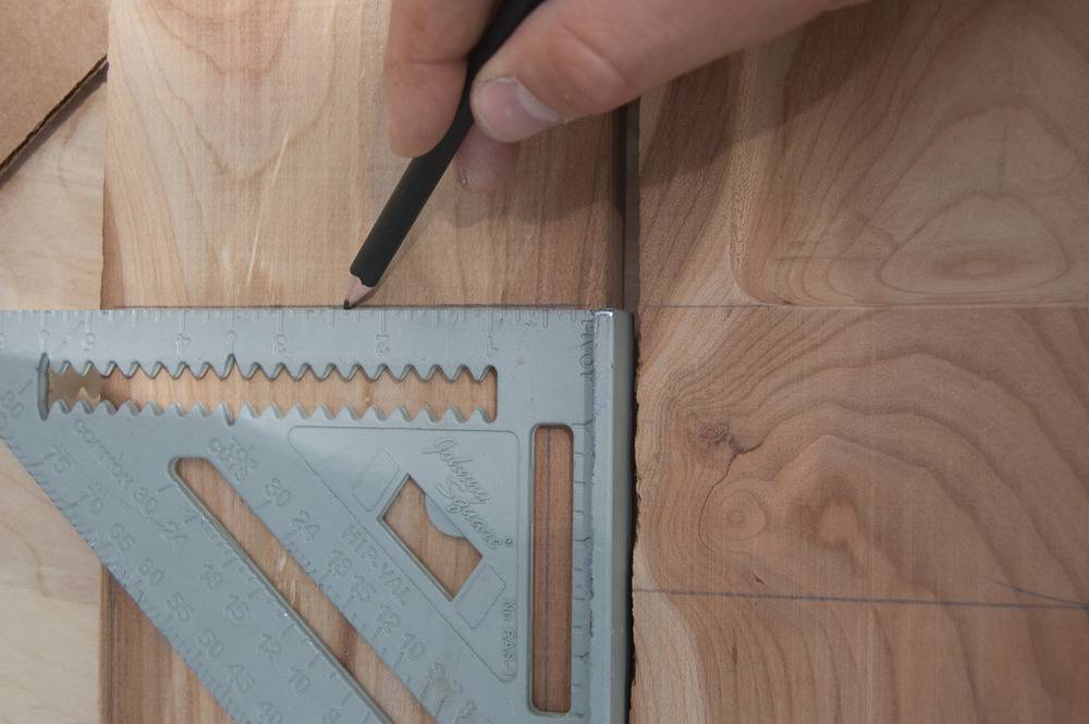 Man drawing lines with the help of triangular scale.