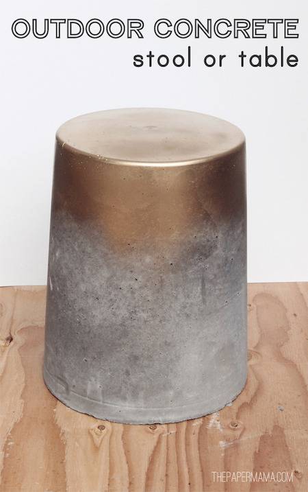 An upside down brass pot with concrete residue around the top.