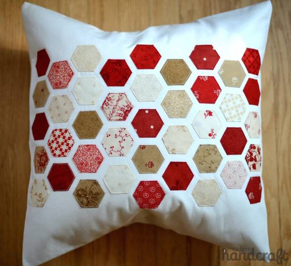 A white pillow with colorful hexagon patterns