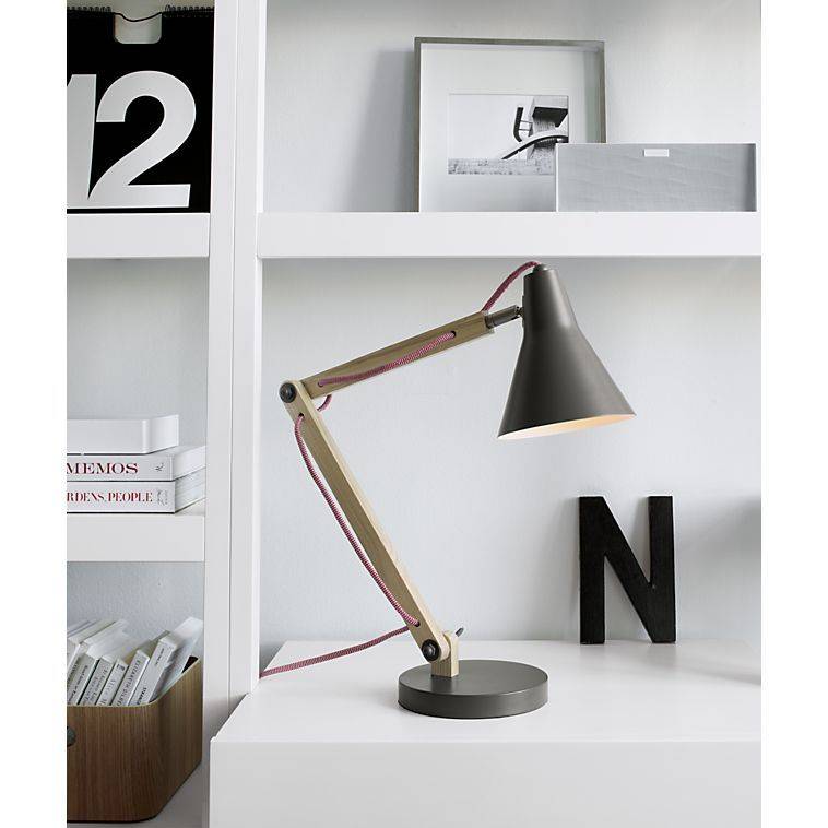 A lamp hangs over the letter N on a desk.