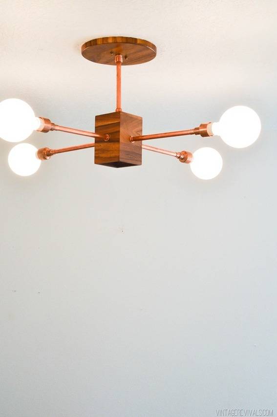 Wooden light chandelier with four lights.
