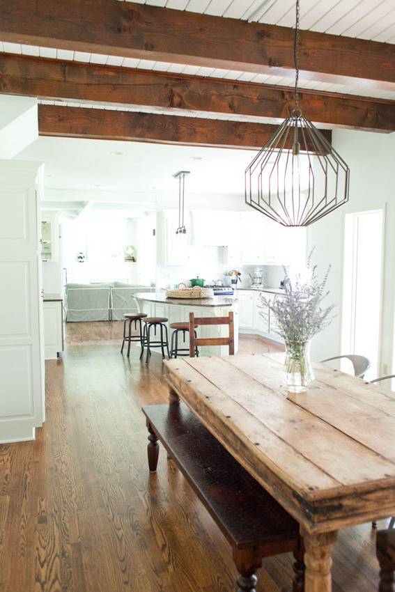 A wooden table sits in a room with a white wall.