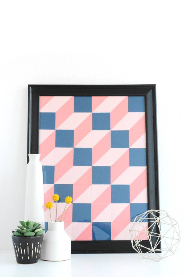 A pink and blue 3D painting is sitting in a frame.