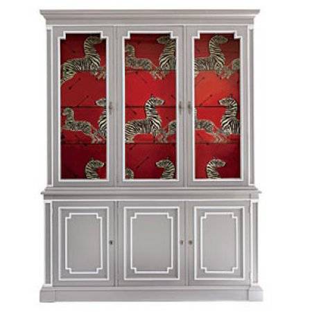 A gray cabinet with white accents and a red interior with zebra decorations.