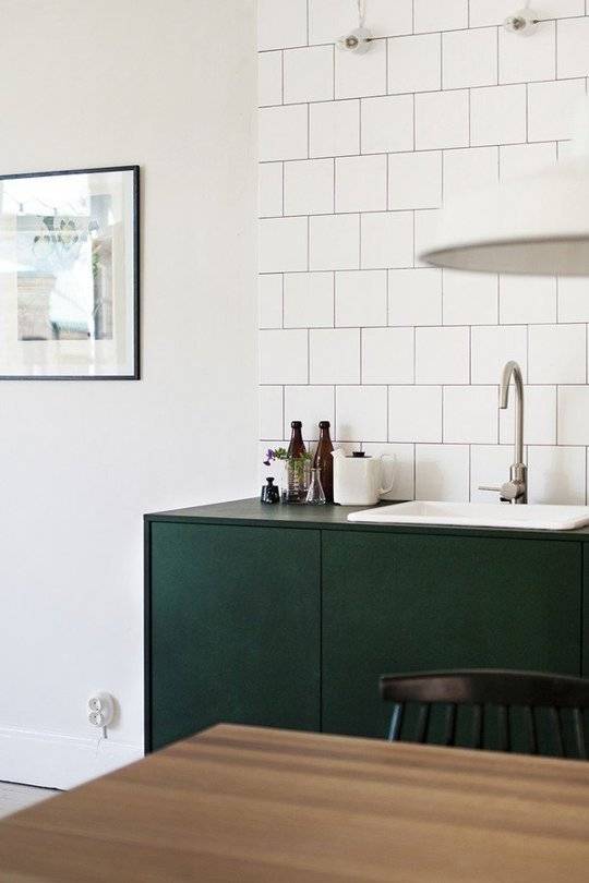 white kitchen tile style wall with green counters