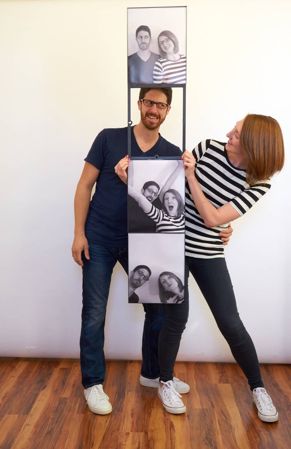 A man and a woman posing behind three photos of them.