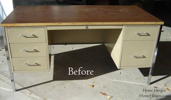 And old metal office desk with a wooden top, sitting outside on concrete ready to be made over.