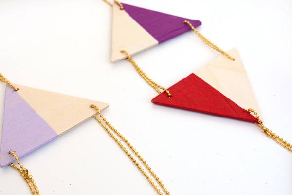 Triangle material with strings hanging from them.