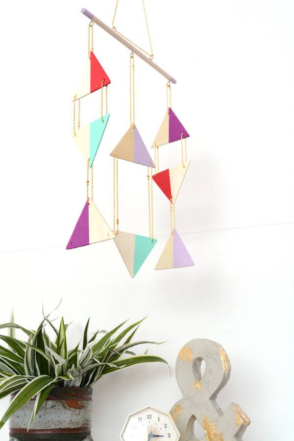 Colorful hanging triangle and a pot of plants