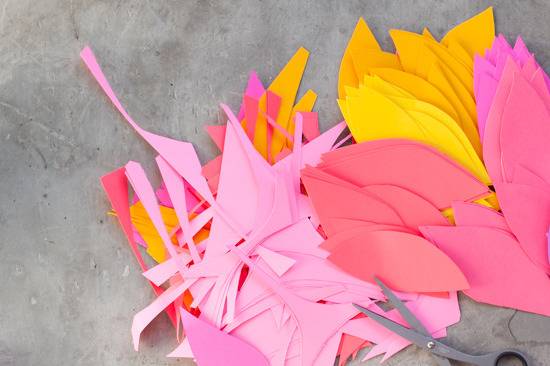 Various colour cardboard leaves with a Caesar lying on the floor