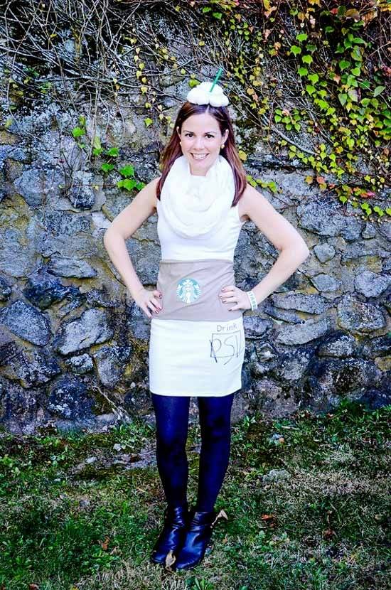 Girl on pumpkin spice latte costume posing in front of the rock wall.