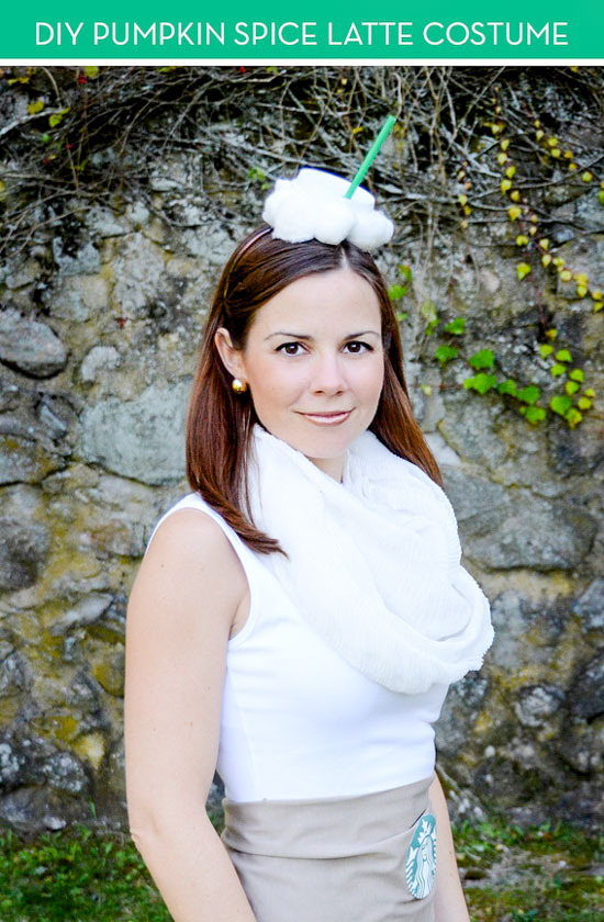 A woman in a white sleeveless shirt, wearing a white scarf with a white flower on her head that has a green stick sticking out of the flower.