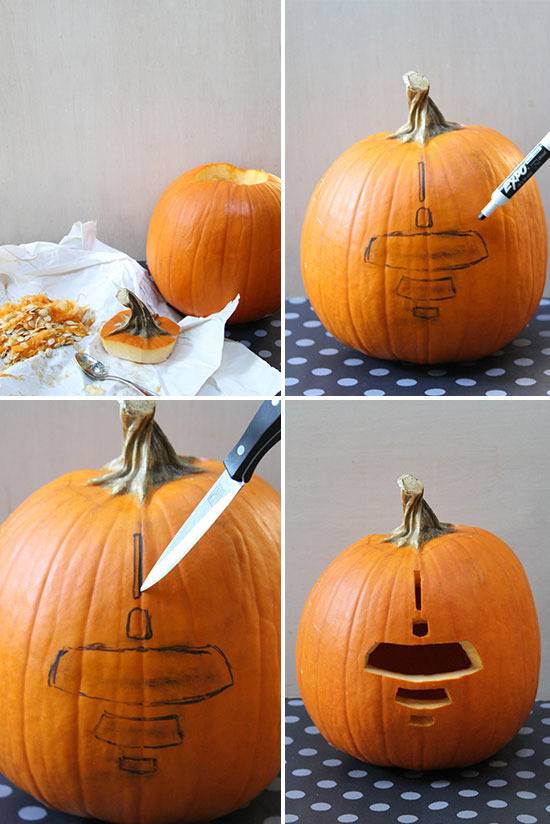A pumpkin has several geometric holes carved in the middle with a knife.