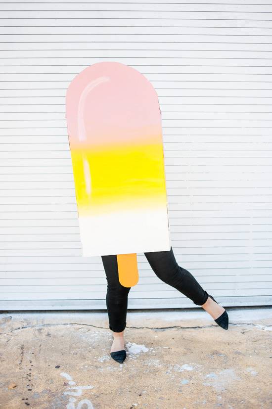 Woman with black shoes is in the popsicle costume.