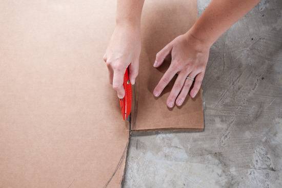 A person is cutting cardboard using knife.