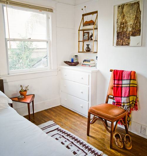 A white room with an orange chair