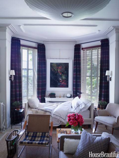 White cozey living room with a a couch bed and slick chairs