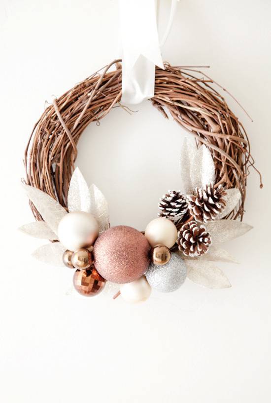 A hanging wreath looks like a bird nest, made with twine, pinecones, and other decorations.