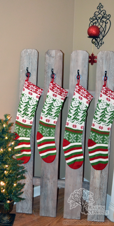 Several Christmas stockings hang from boards.