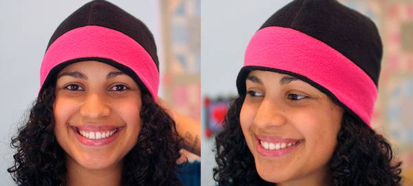 A teenage girl smiles with beanie hat